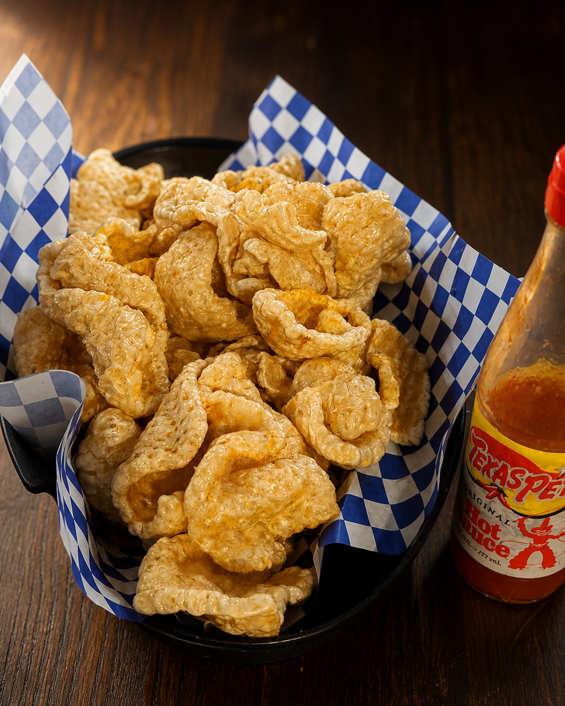 Crispy pork rinds with Texas Pete